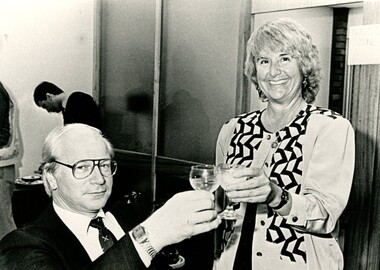 Caroline Hogg clinks her glass with an unidentified man