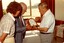 Three people examine a mantel clock