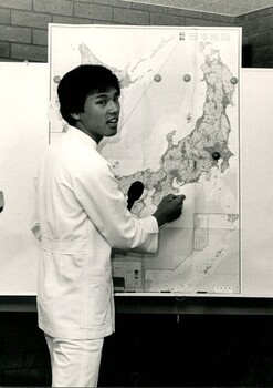Man adding marker pins to a map of Japan
