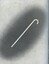 White cane on darkened grey background which lightens around the edges