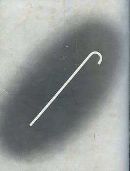 White cane on darkened grey background which lightens around the edges