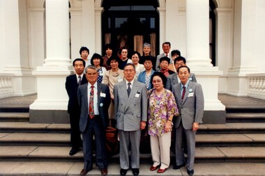 17 Japanese people stand on the steps of Government House
