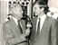 Arthur Wilkins holds a microphone as he speaks to Jeff Kennett with magnetic reels in the background