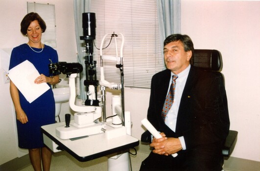Rob Knowles sits in client chair at eye examination station