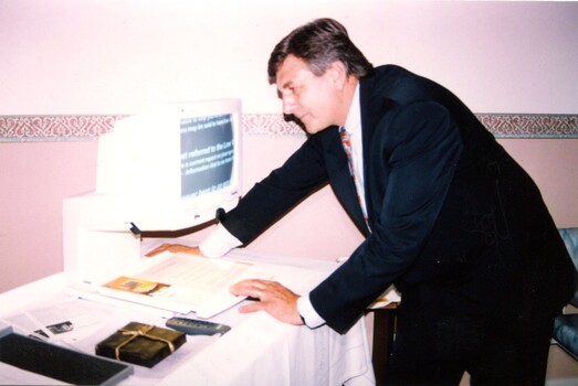 Rob Knowles views computer screen with magnifier displayed at clinic