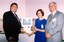 Rob Knowles, unknown woman and John Cook with magnified screen