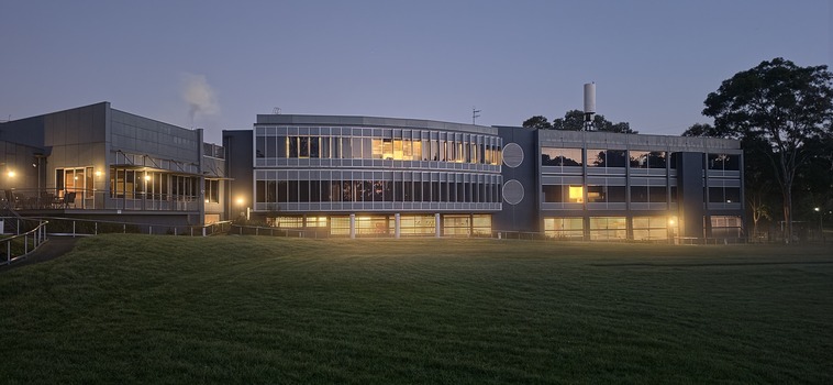 Rear view of Glenferrie Road building with lights on early morning