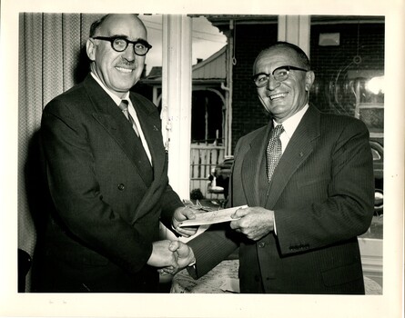 Hugh Robertson hands a cheque to Bruce Small