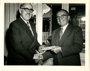 Hugh Robertson hands a cheque to Bruce Small