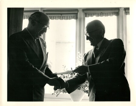 Hugh Robertson hands a cheque to Bruce Small