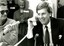 Mal Walden on telephone with cake in front of him and people singing