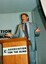 Max Walker addressing the audience from the podium with elaborate gestures