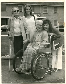 Four females outside Elanora, one in a wheelchair and the other with a white cane