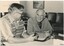 Two men operate a CB radio