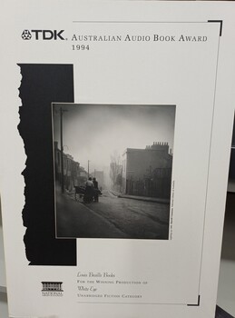 Photograph of two people standing by cart at the top of a city road