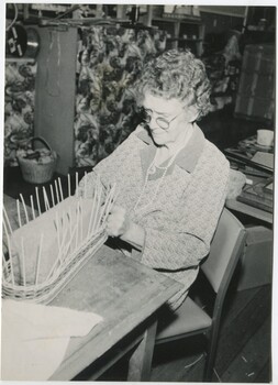 Woman making a small long basket