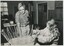 Man talks to girl who is making a basket
