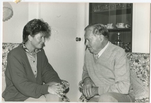 Woman speaking with a man in a lounge room