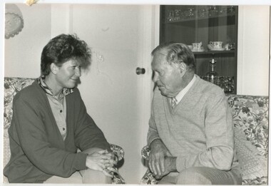Woman speaking with a man in a lounge room