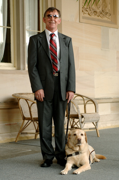 Kevin Murfitt with his dog guide at Government House