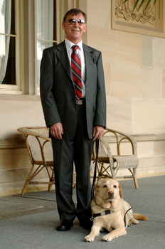 Kevin Murfitt with his dog guide at Government House