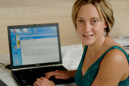 Prue Watt with her hands on a computer keyboard