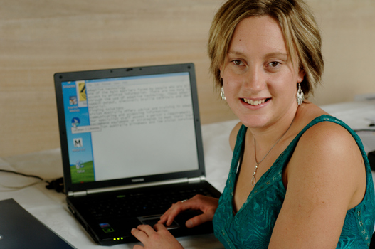Prue Watt with her hands on a computer keyboard