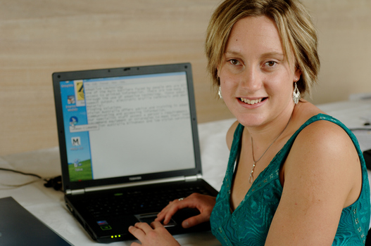 Prue Watt with her hands on a computer keyboard