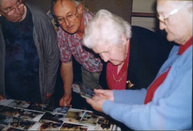 Rhonda Peters, Ian Mills, Connie Pigdon and Eleanor McDonald look at images