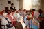 Primary school children playing musical instruments in nursing home