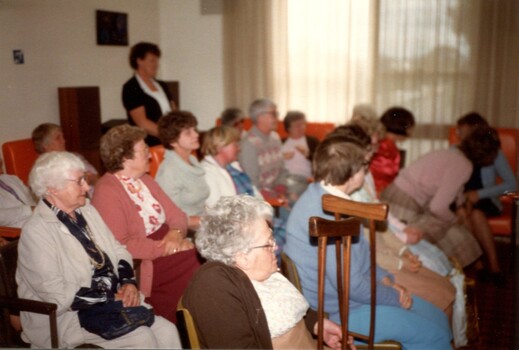 Primary school children playing musical instruments in nursing home