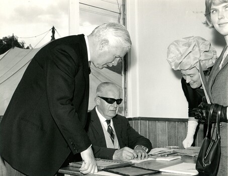 Sir Rohan watching a man hand punch Braille