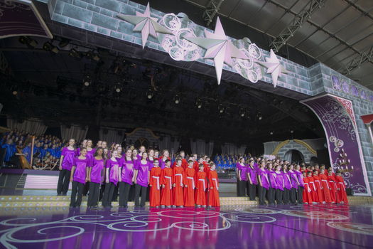 Children's choirs on stage for crowd warm up