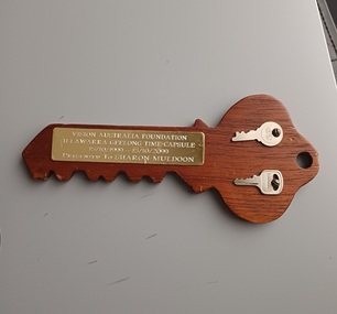 Wooden key with plaque and two metal keys attached