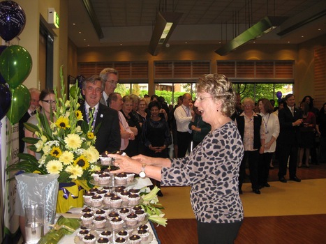 Jennifer happily views the tiers of cupcakes and beautiful flowers