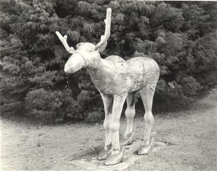 A sculpture of a moose wearing hight heel shoes