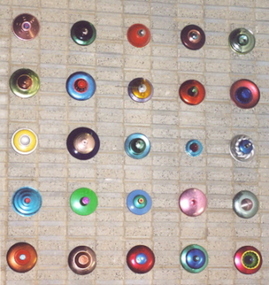 Anodised aluminum lids forming a wall sculpture