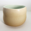 Brown ceramic vessel with green interior