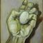 A hand holding an egg
