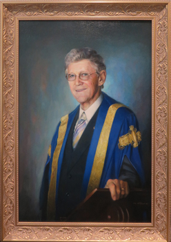 Portrait of Robert H.T. Smith in academic regalia