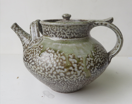 A lidded teapot with mottled salt glazing