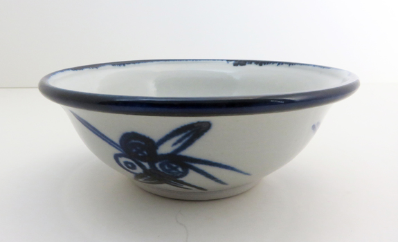 Black and white bowl with floral design on the side 