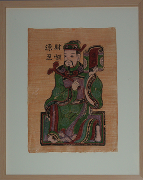 Man kneeling holding a scroll