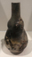 Tall thin pit fired bottle 