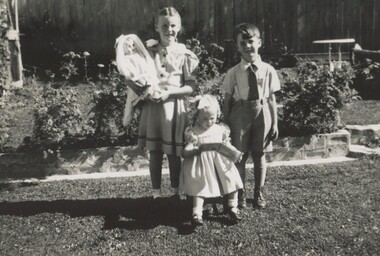 Photograph, Young family children in backyard of 11 York Street, Mont Albert, c1948 - perhaps Christmas