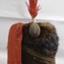 A soldier's hat with a tall feather on the top and metal chinstrap. 