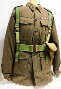 A heavy cloth jacket with metal and cloth badges. 