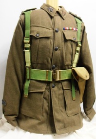 A heavy cloth jacket with metal and cloth badges. 