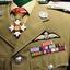 Soldier's uniform showing badges and medal ribbons.