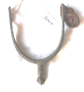 Curved metal object with spiked wheel on end